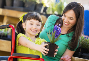 In home nurse helping child with physical therapy